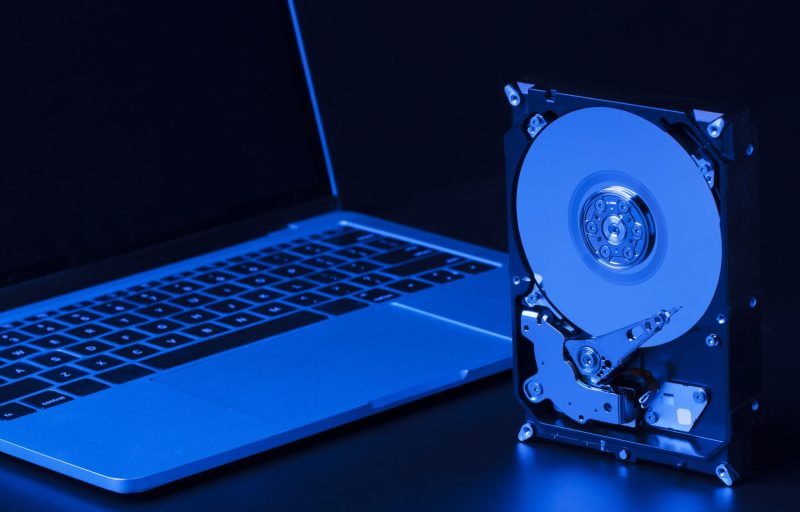 hard-drive-with-blue-light-laptop-high-angle hard-drive-with-blue-light-laptop-high-angle